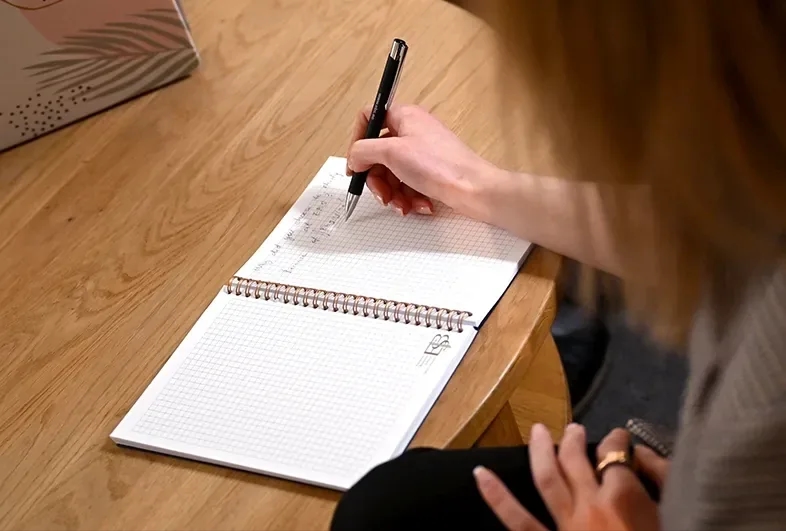 Writing in notebook
